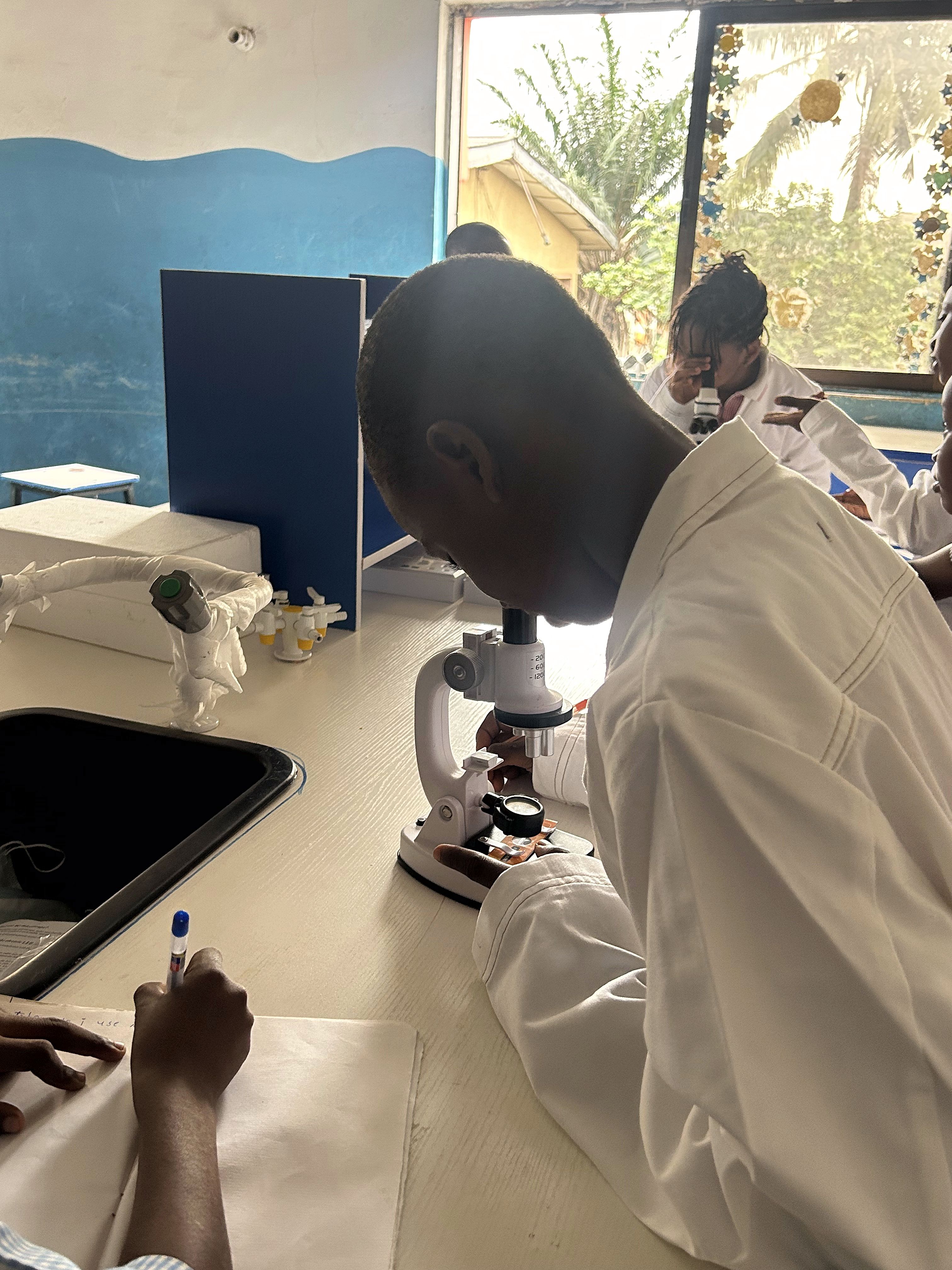 Student looking through a microscope